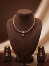Green and red stone pearl necklace set with floral choker design, freshwater pearls, and matching drop earrings.