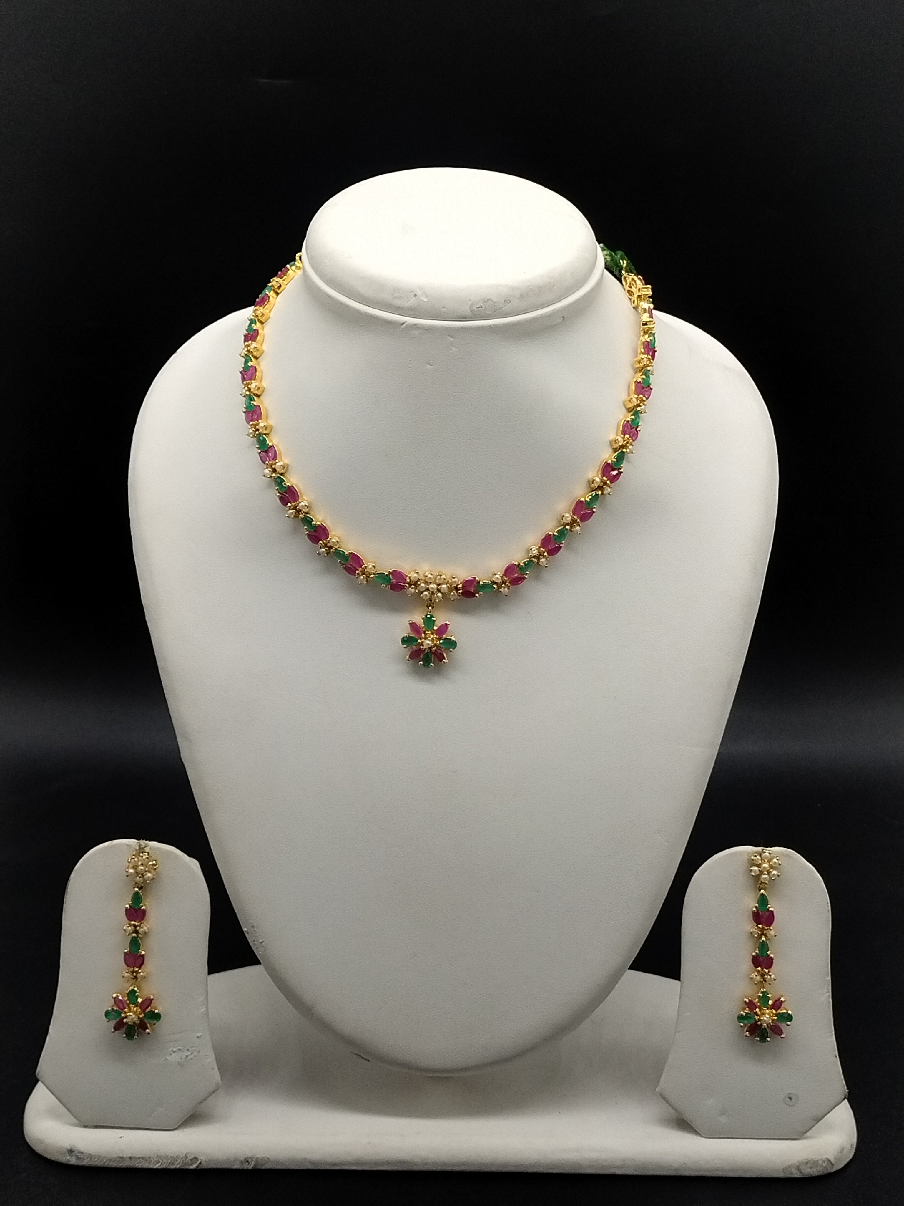 Green and red stone pearl necklace set with floral choker design, freshwater pearls, and matching drop earrings.