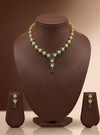 Green and white stone necklace set with floral motifs and matching drop earrings.