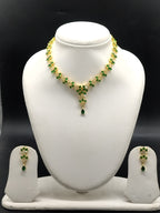 Green and white stone necklace set with floral motifs and matching drop earrings.