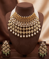 Kundan choker set with light green and white stones, layered detailing, pearl-inspired drops, and matching earrings.