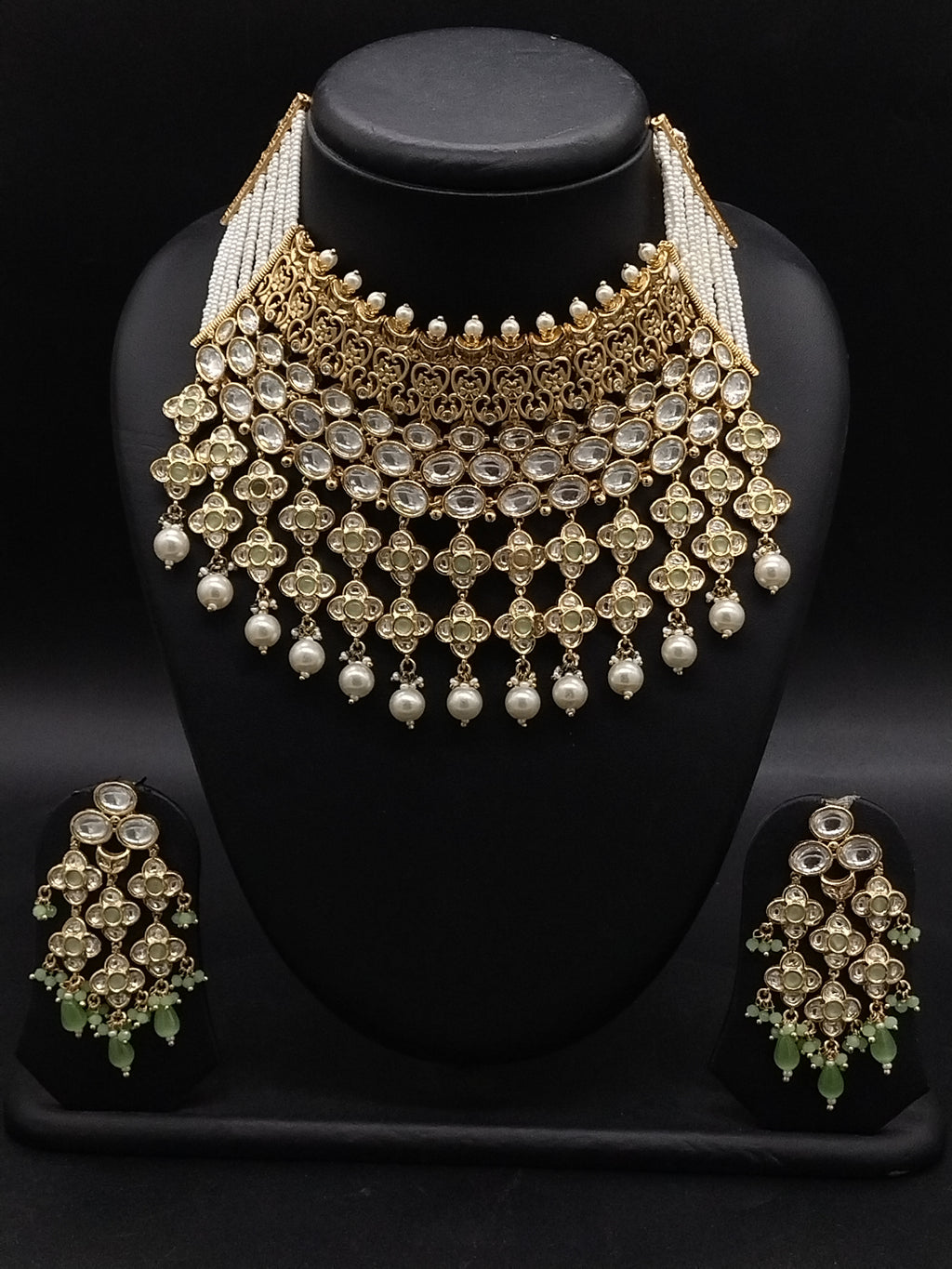 Kundan choker set with light green and white stones, layered detailing, pearl-inspired drops, and matching earrings.
