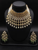 Kundan choker set with light green and white stones, layered detailing, pearl-inspired drops, and matching earrings.
