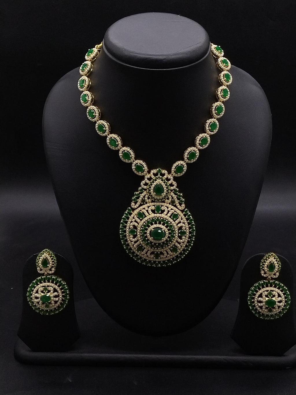 Long necklace set with emerald-inspired green stones, white American Diamond detailing, and matching chandelier earrings.