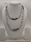 Midnight Ripple freshwater pearl necklace with irregular white pearls and black beads in layered multi strand design