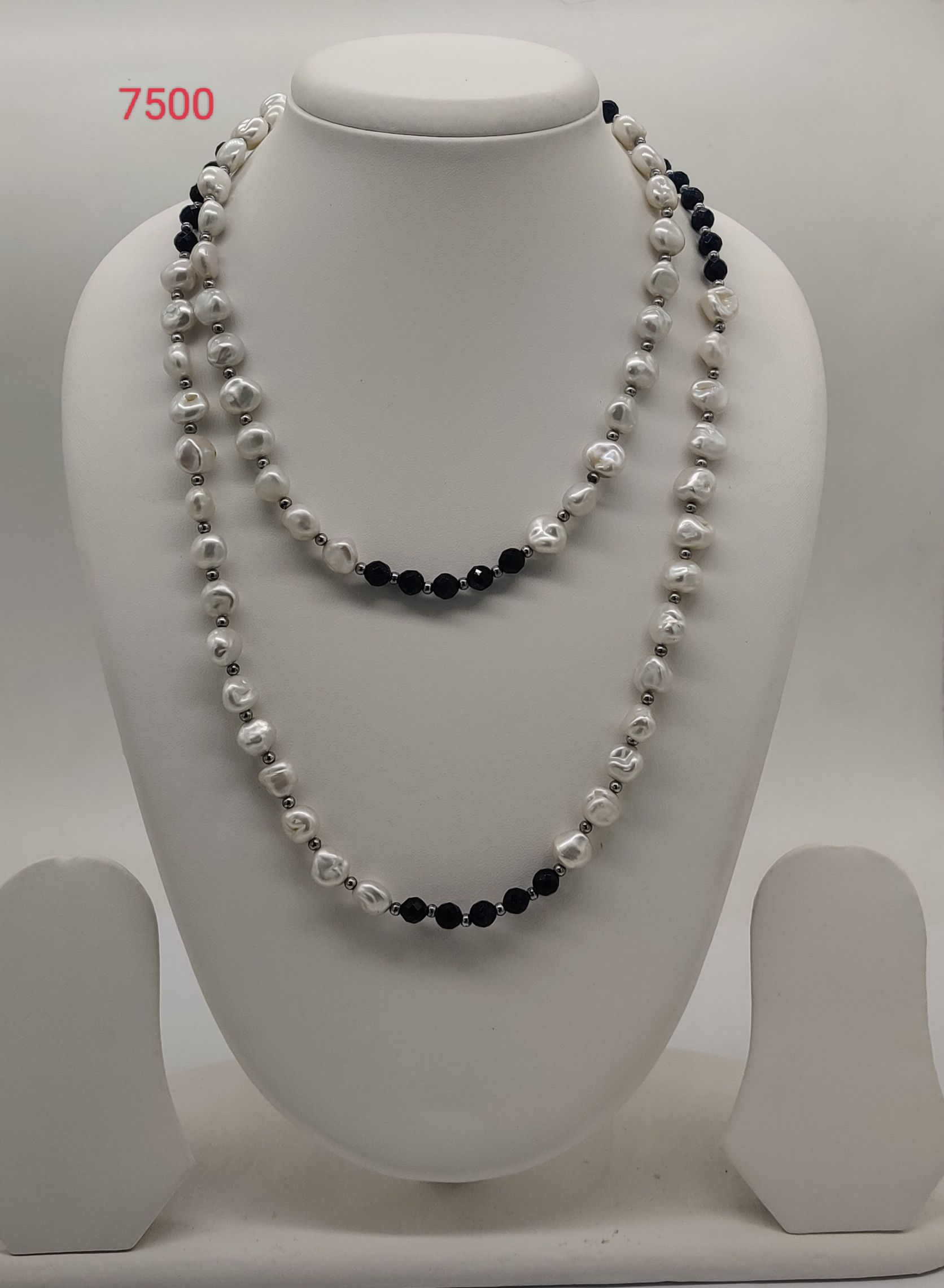 Midnight Ripple freshwater pearl necklace with irregular white pearls and black beads in layered multi strand design