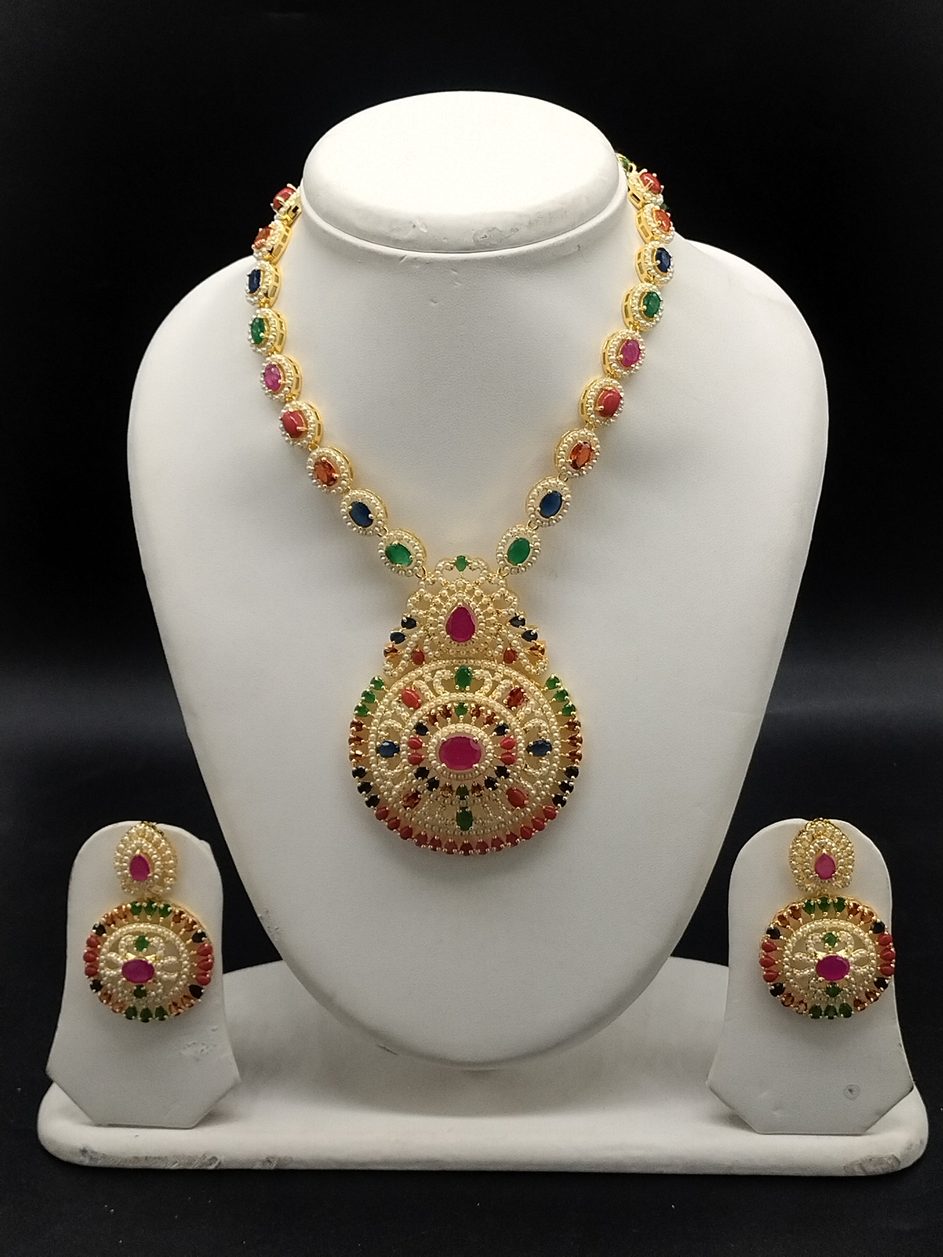 Navaratna multicolour stone necklace set with traditional gold-tone design and matching stud earrings.
