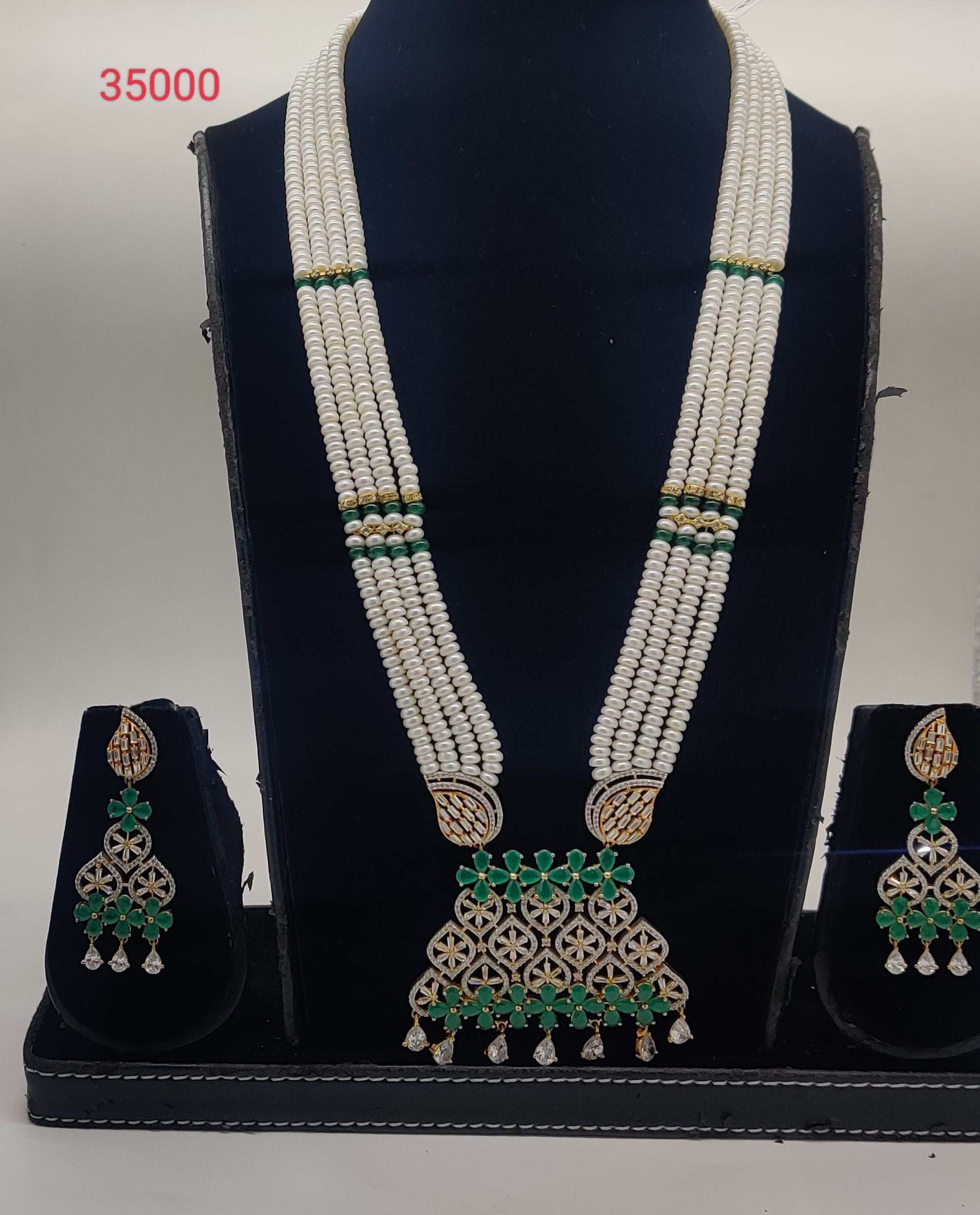 Emerald Petal four-line flat freshwater pearl pendent set with emerald green beads and floral stone design