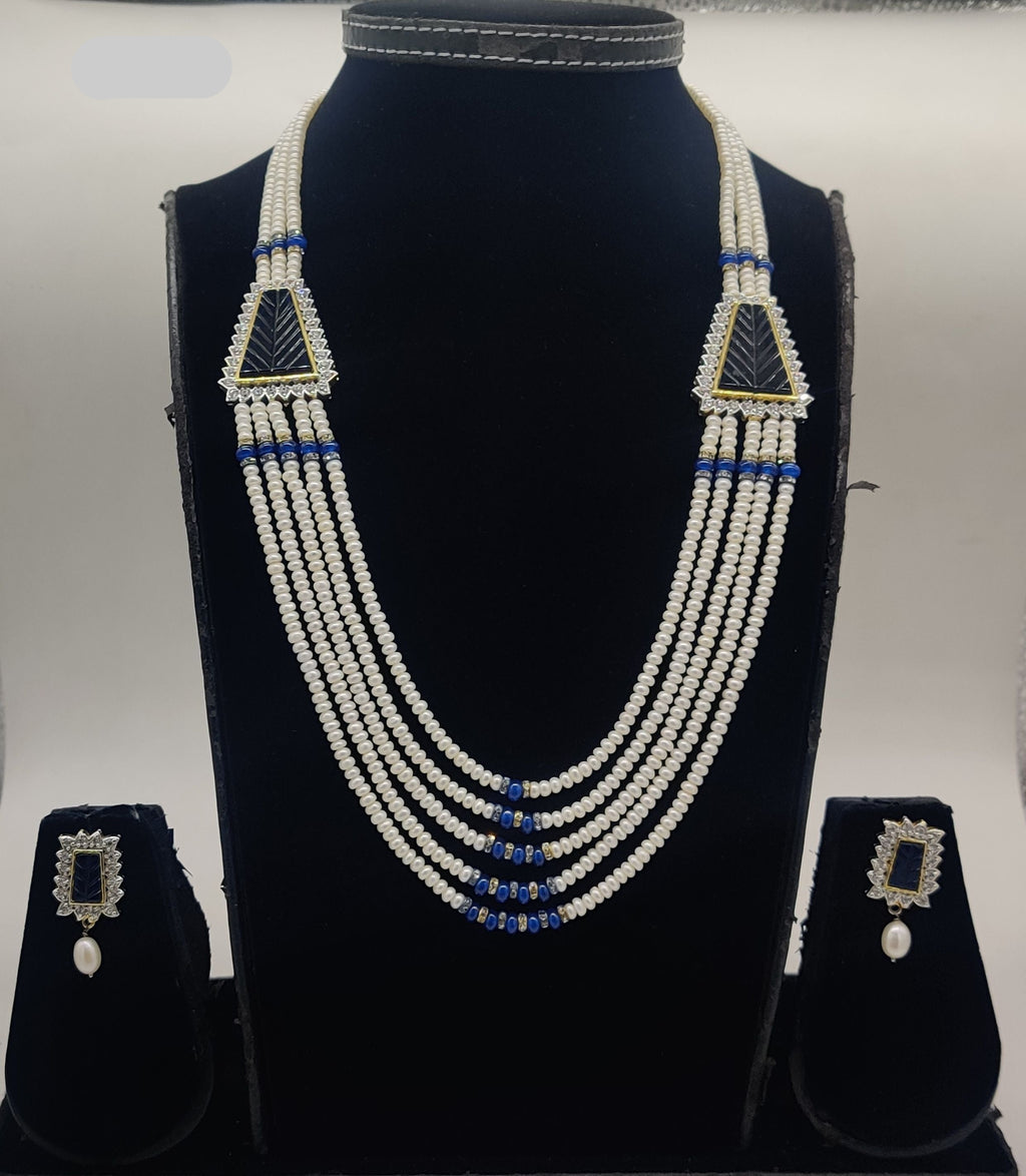 Five-line freshwater pearl broach set with blue bead accents and dual triangular centerpiece elements with matching rectangular earrings.