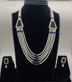 Five-line freshwater pearl broach set with blue bead accents and dual triangular centerpiece elements with matching rectangular earrings.