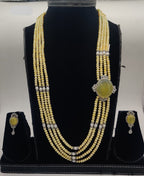 Four-line freshwater yellow pearl broach set with oval citrine-tone gemstone and silver detailing with matching earrings.
