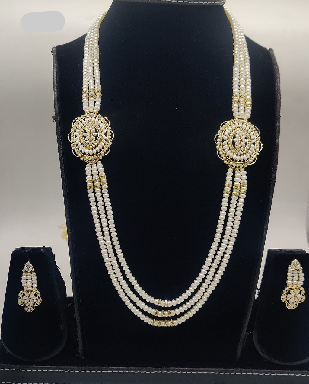 Three-line freshwater pearl broach set with gold-toned heritage medallions and coordinated earrings.
