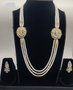 Three-line freshwater pearl broach set with gold-toned heritage medallions and coordinated earrings.