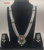Emerald Serenity Floral four-line oval freshwater pearl pendent set with green stone floral design and matching earrings