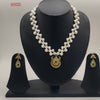 Golden emerald glow two-strand freshwater pearl necklace set with round gold pendant and green gemstone detailing