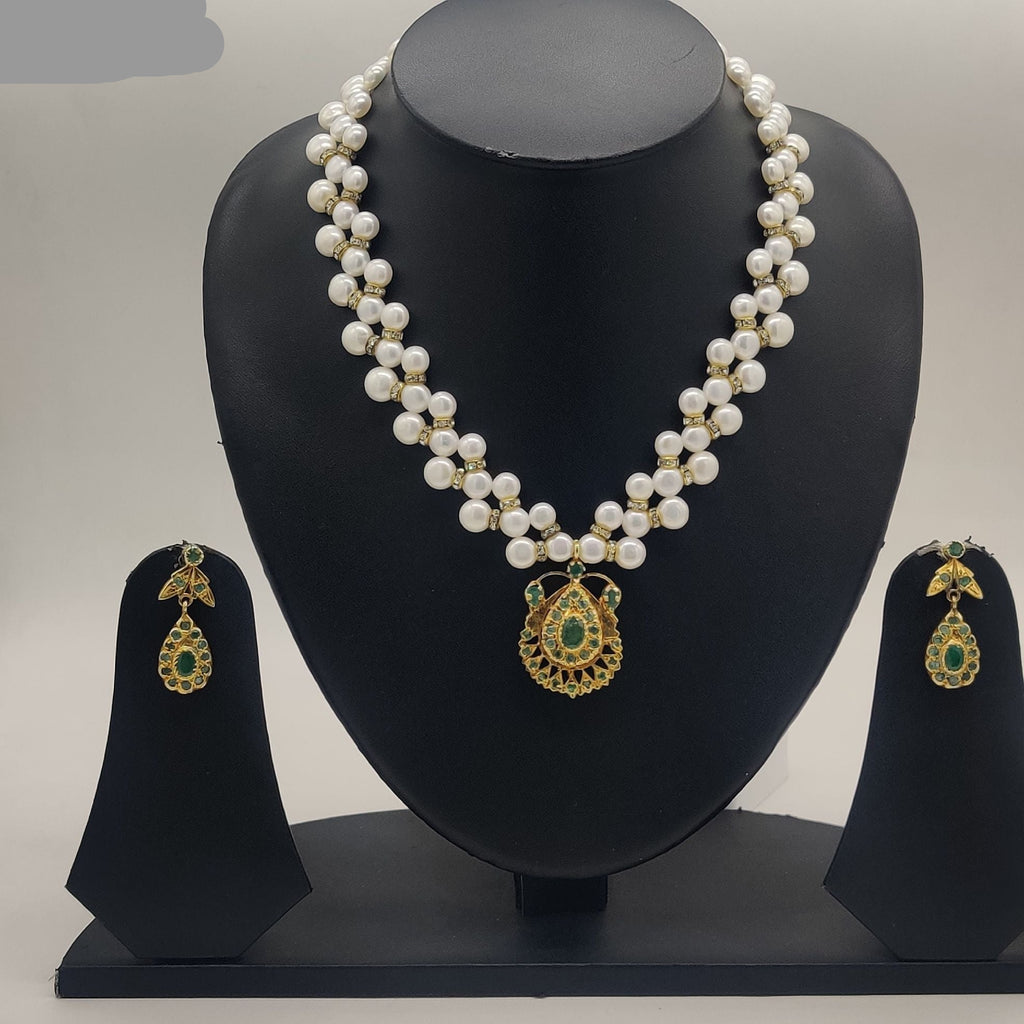 Golden emerald glow two-strand freshwater pearl necklace set with round gold pendant and green gemstone detailing