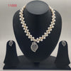 Kundan blossom freshwater pearl double-strand pendant set with red floral kundan design and matching earrings