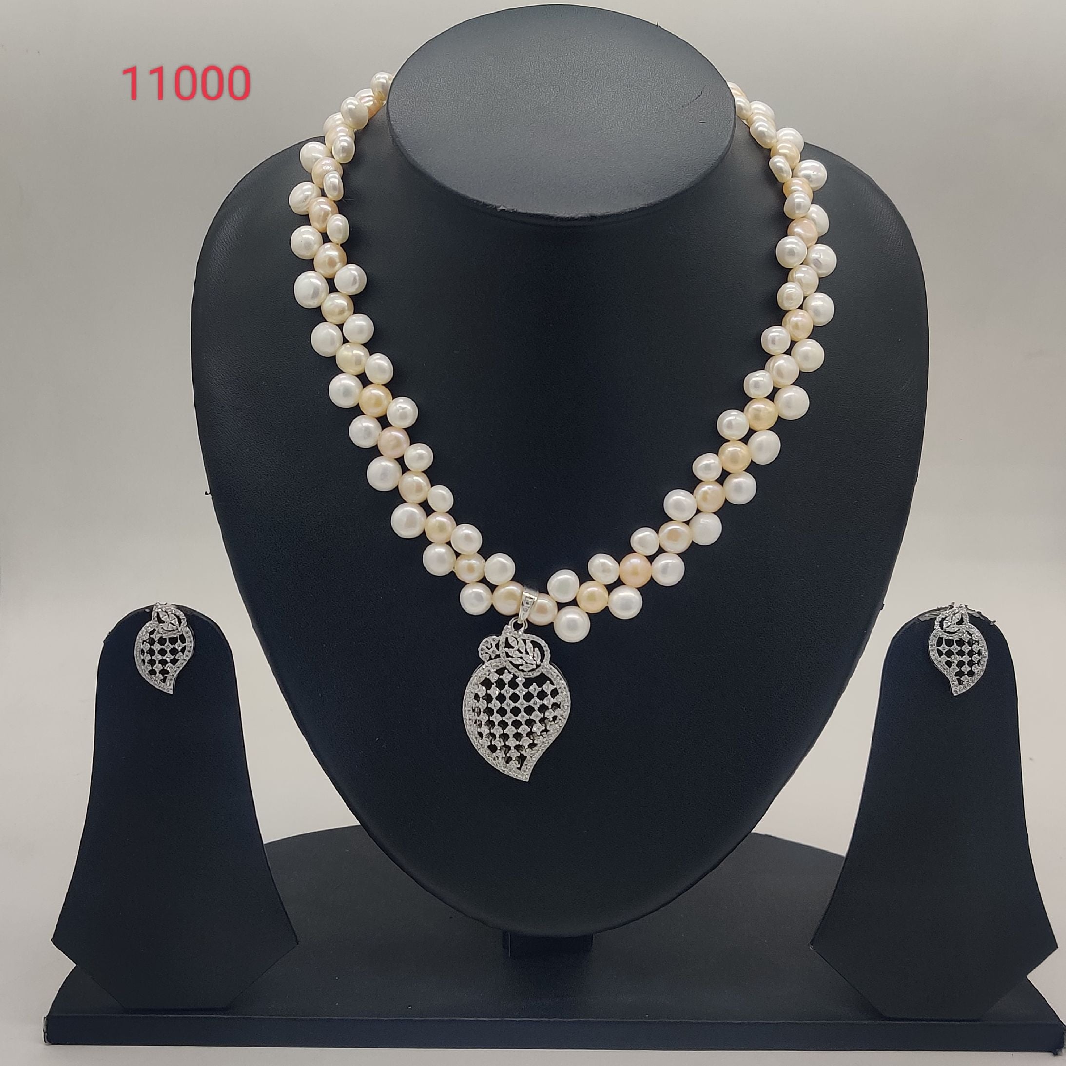 Kundan blossom freshwater pearl double-strand pendant set with red floral kundan design and matching earrings