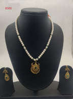 One line freshwater pearl necklace and earrings set with gold toned green emerald pendant