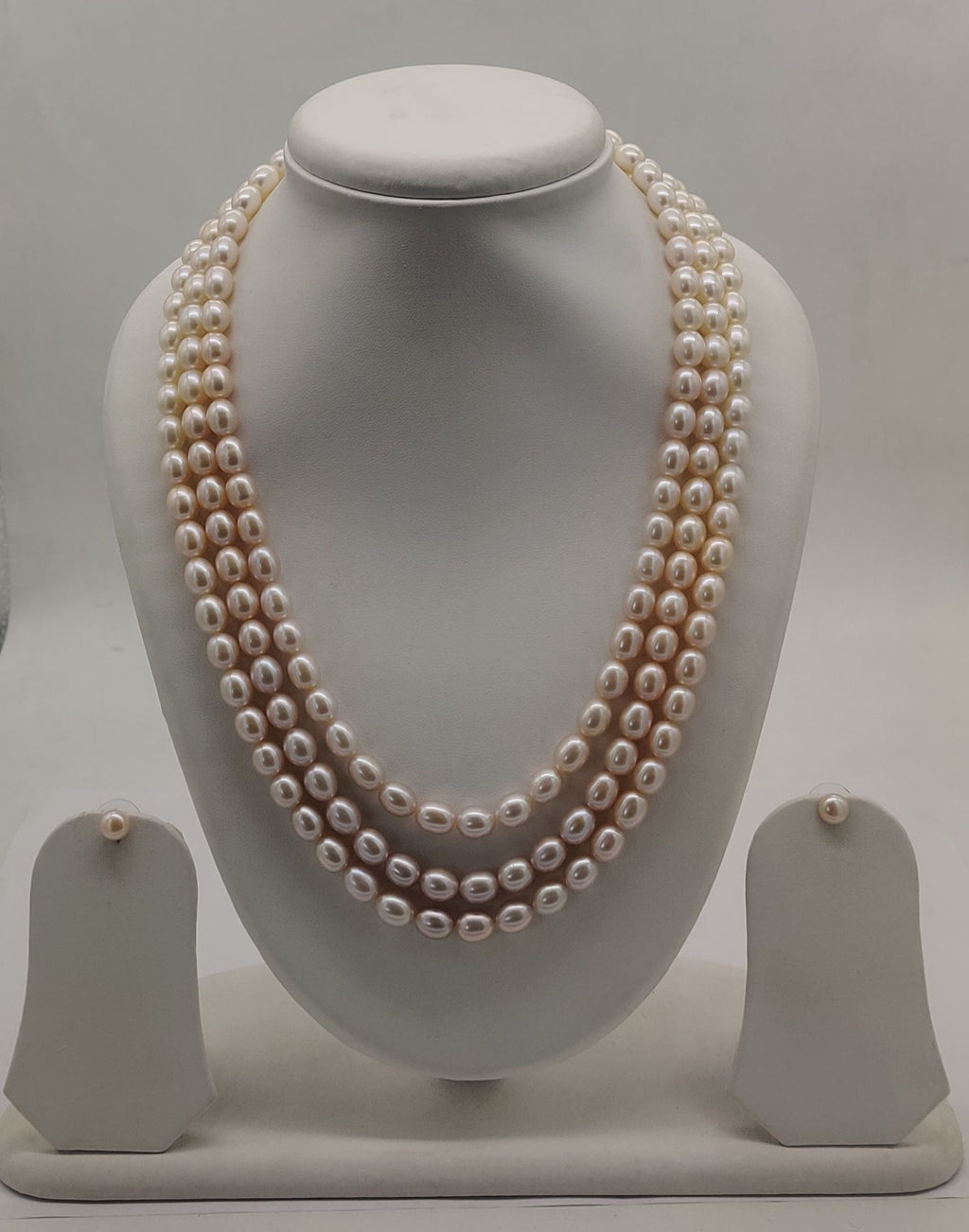 Three-line freshwater pearl necklace and earrings set for women with soft peach pearls