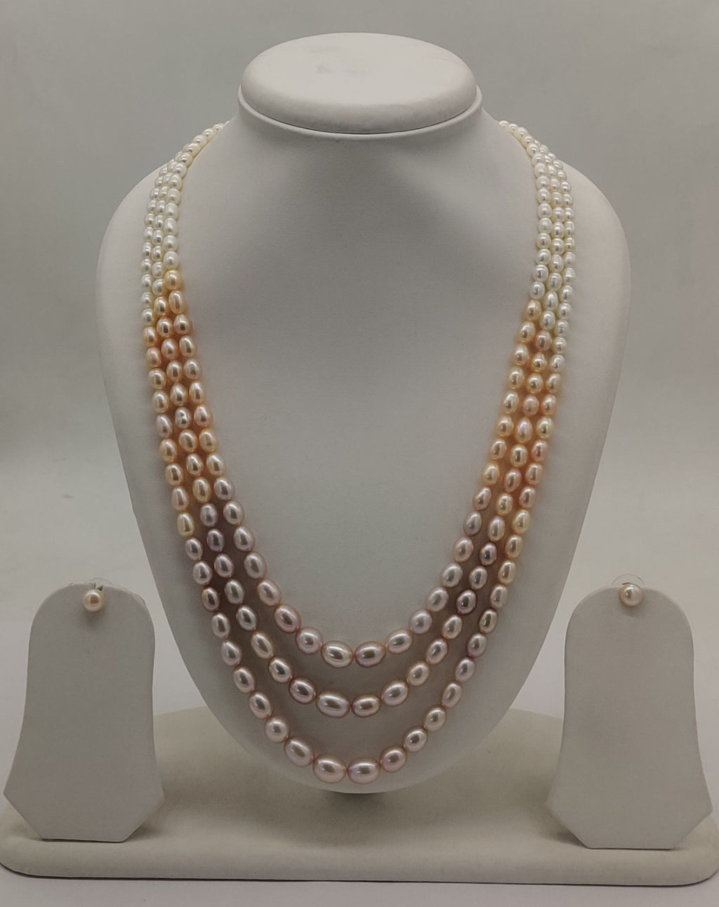 Three-line freshwater pearl necklace and earrings set for women with shaded oval pearls