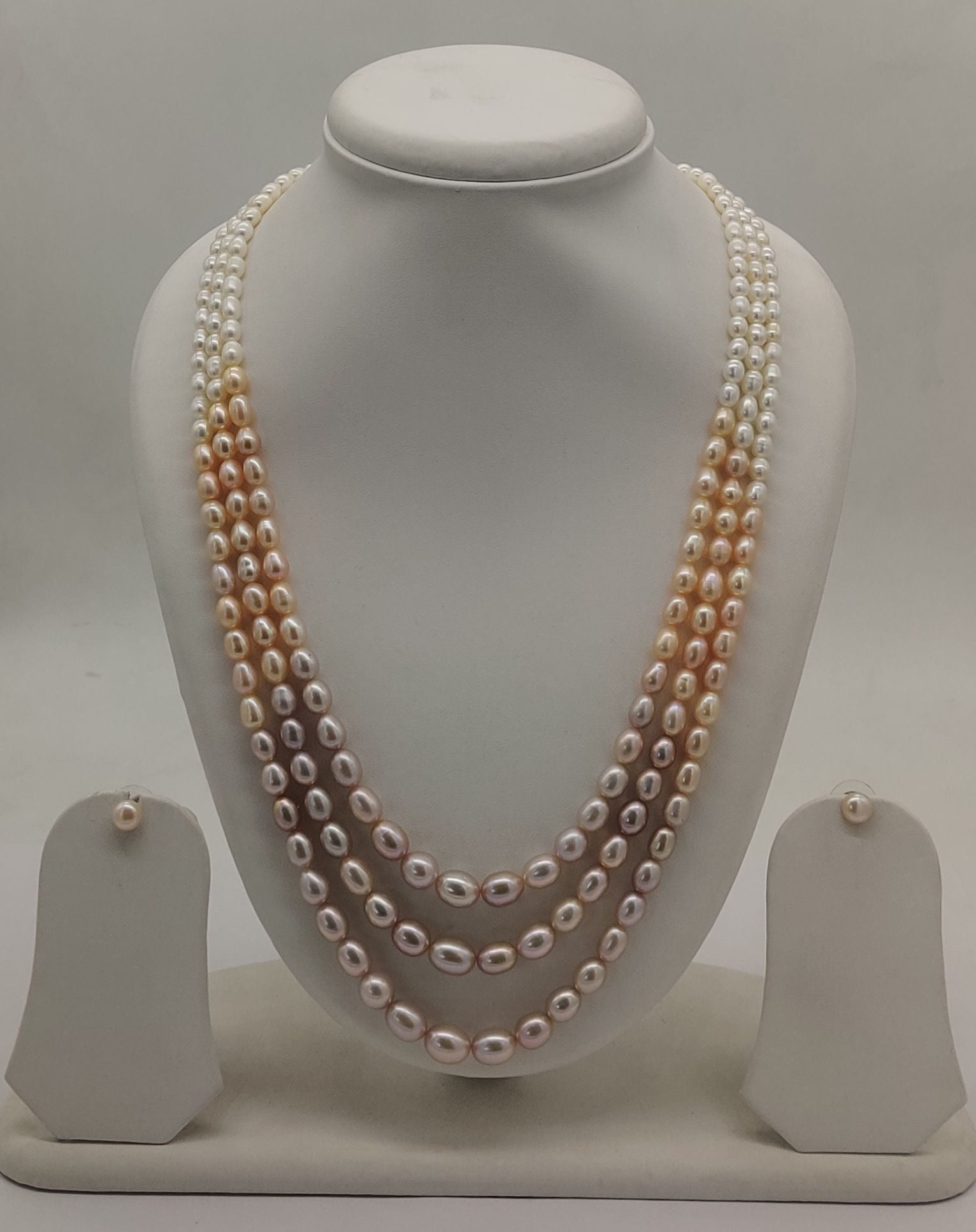 Three-line freshwater pearl necklace and earrings set for women with shaded oval pearls