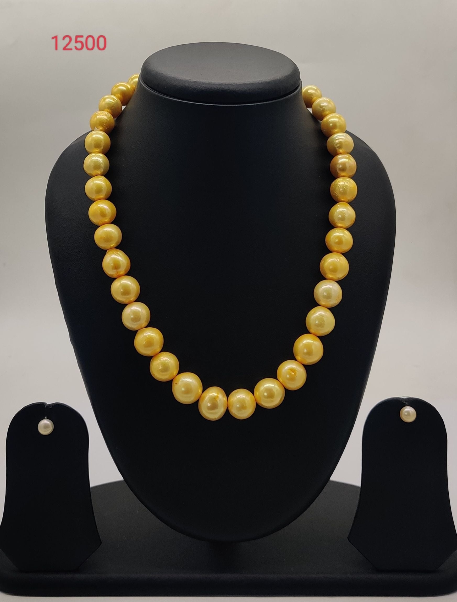 single strand golden freshwater pearl necklace and earrings set with graduated round pearls