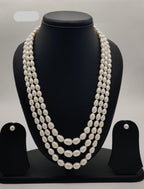 Three-strand freshwater pearl necklace and earrings set for women with oval white pearls