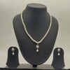 One line freshwater pearl necklace and earrings set with white pearls and central larger pearl pendant