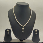 One line freshwater pearl necklace and earrings set with white pearls and central larger pearl pendant