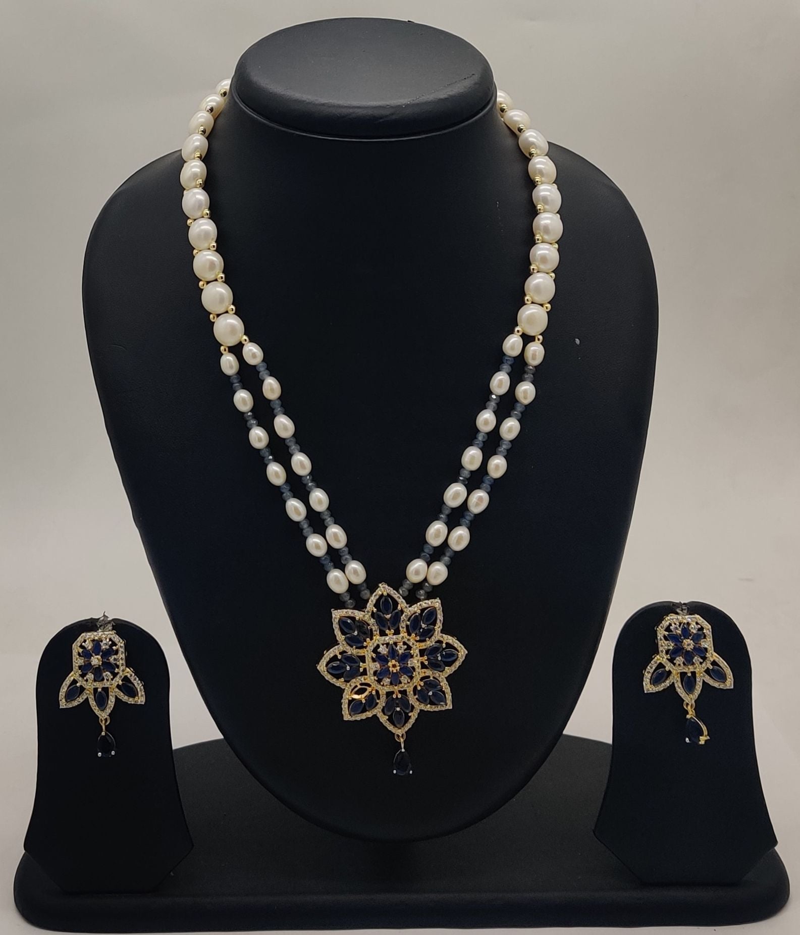Blue bloom freshwater pearl two-strand pendant set with floral blue and clear stone design and matching earrings