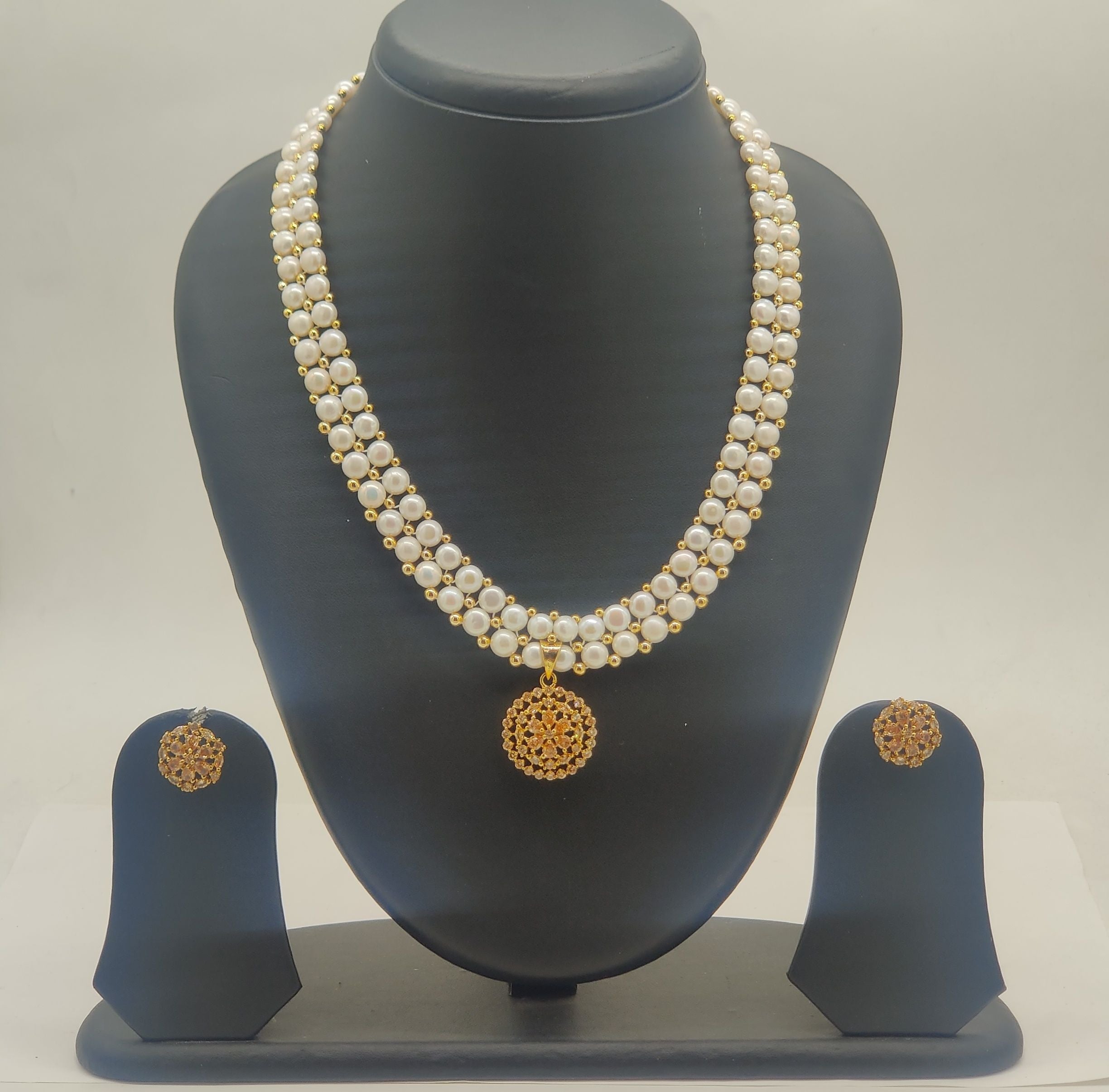 Royal gold freshwater pearl double-strand pendant set with ornate circular medallion and matching stud earrings