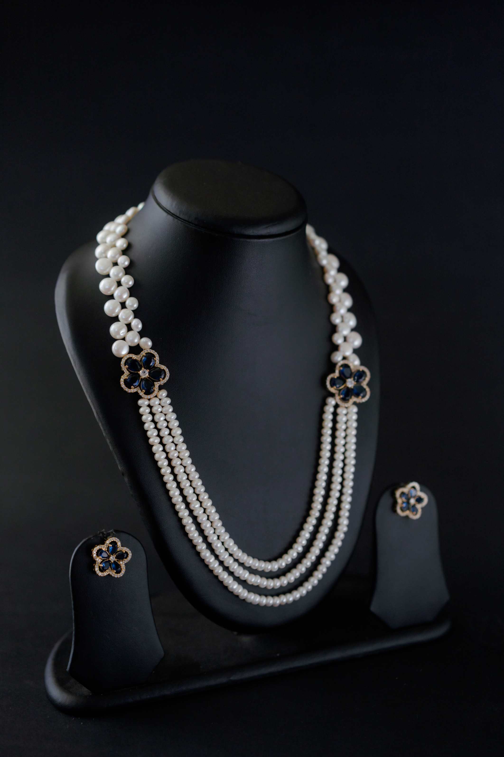 Midnight Bloom Multi-Strand Freshwater Pearl Broach Set with Deep Blue Floral Motifs and Matching Earrings