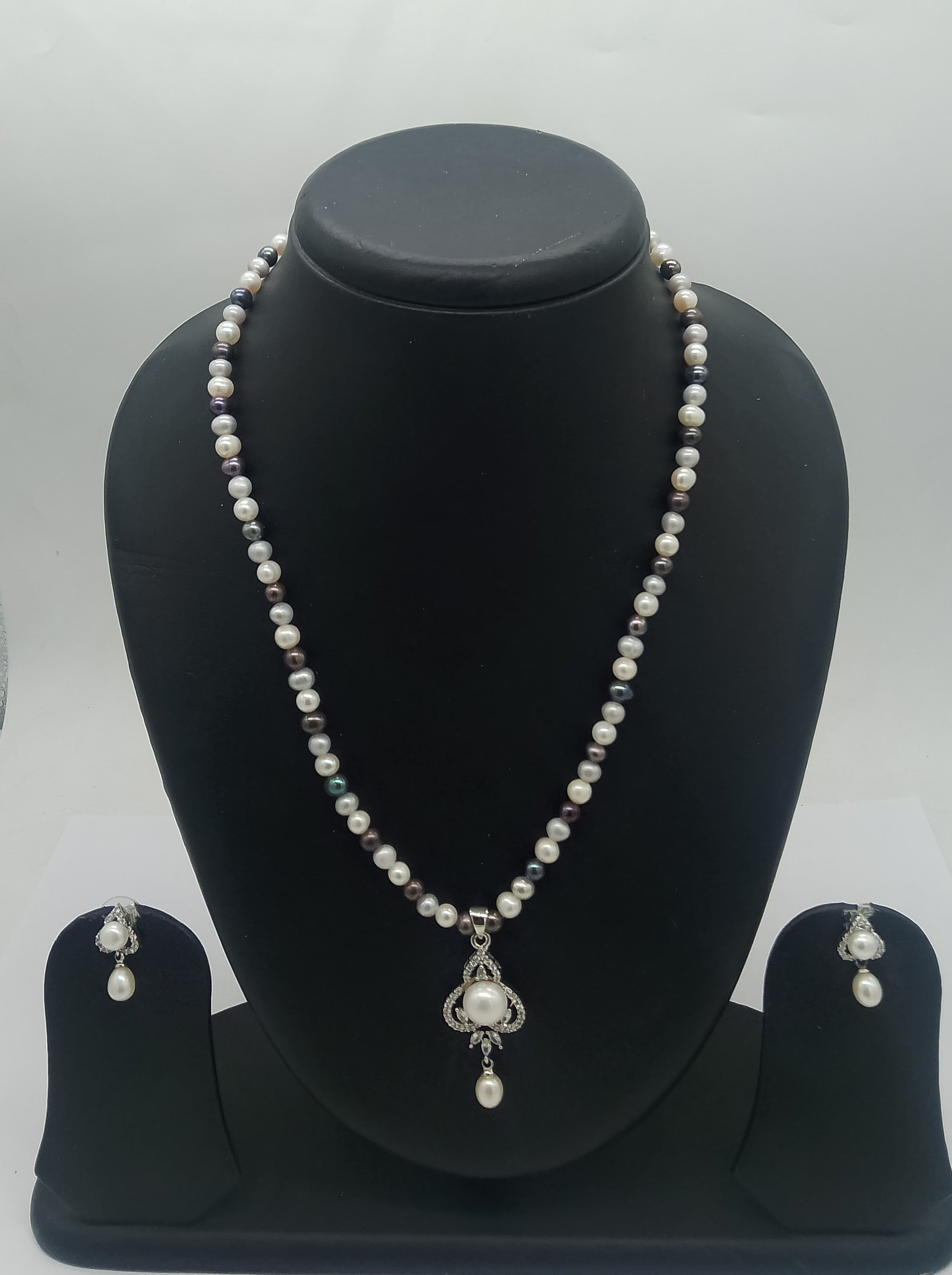 One line freshwater pearl necklace and earrings set with sculpted silver-toned pendant and dangling pearl