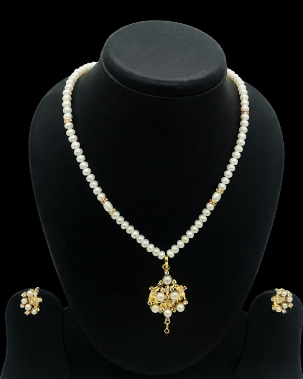 One line freshwater pearl necklace and earrings set with ornate sculpted pendant and gold-toned accents