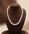 One-line South Sea white round pearl mala with graduated 8 mm to 14 mm pearls.