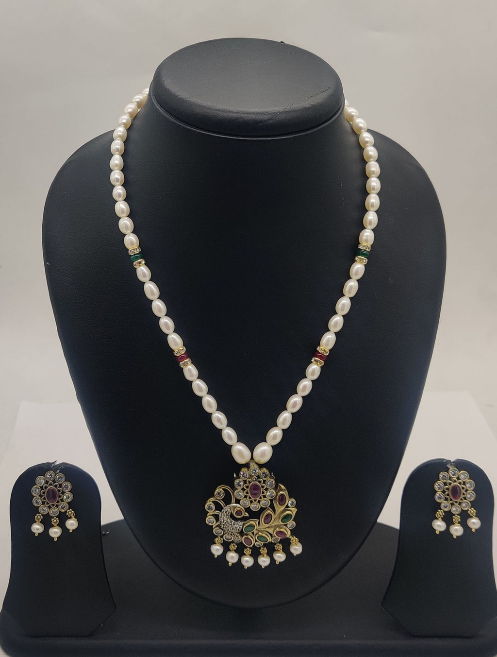One line freshwater pearl necklace and earrings set with peacock-inspired pendant and matching motif earrings