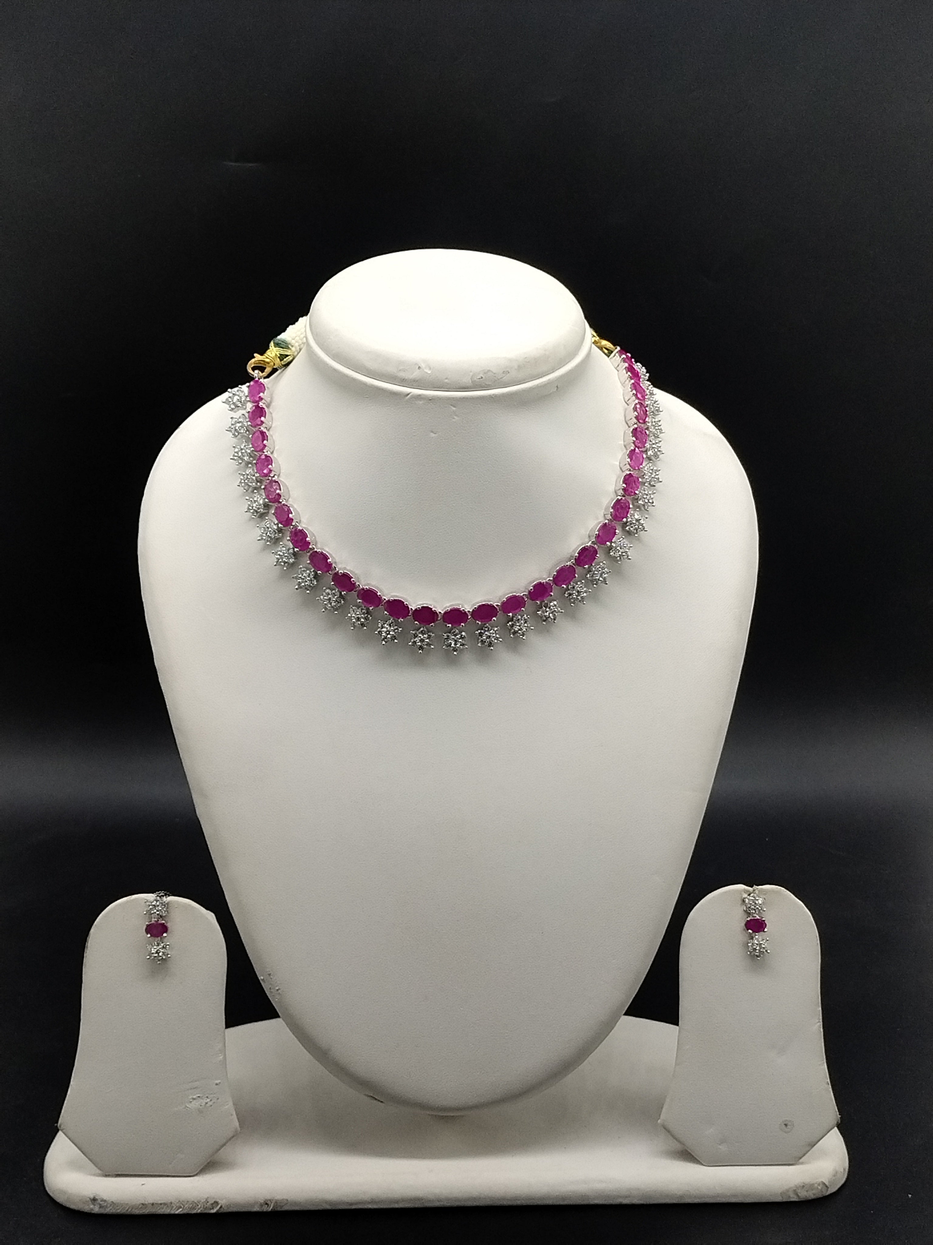 Rani pink and white American Diamond necklace set with floral design and matching drop earrings.