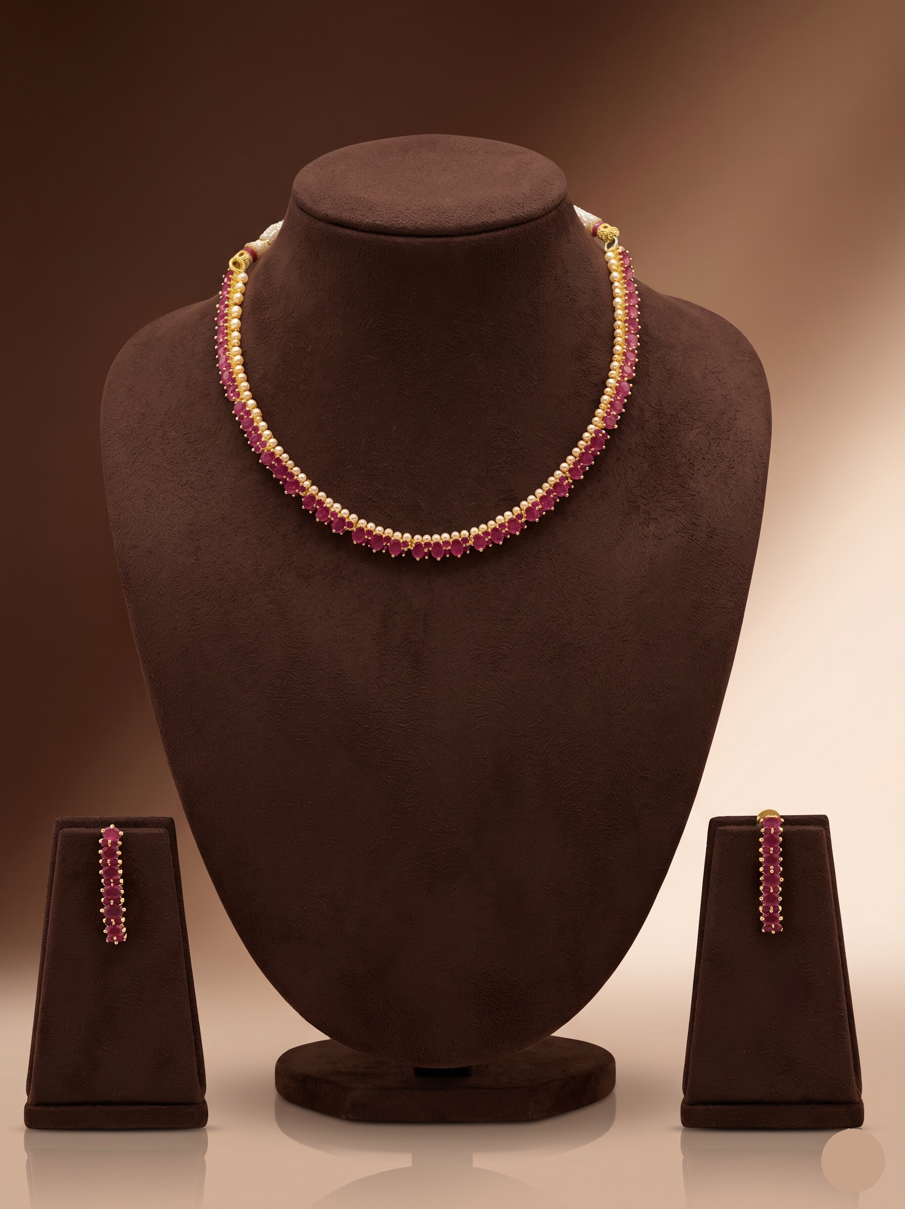 Red stone designer necklace set with oval-cut stones, gold-toned bead accents, and matching long drop earrings.