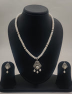 One line freshwater pearl necklace and earrings set with white pearls and silver-toned central pearl drop pendant
