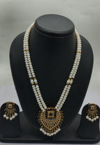 Regal Pearl Noir two line freshwater pearl pendant necklace set with flat white pearls and black gold centerpiece