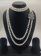 Regal Radiance freshwater pearl choker necklace set with layered round white pearls and stone-studded silver clasp