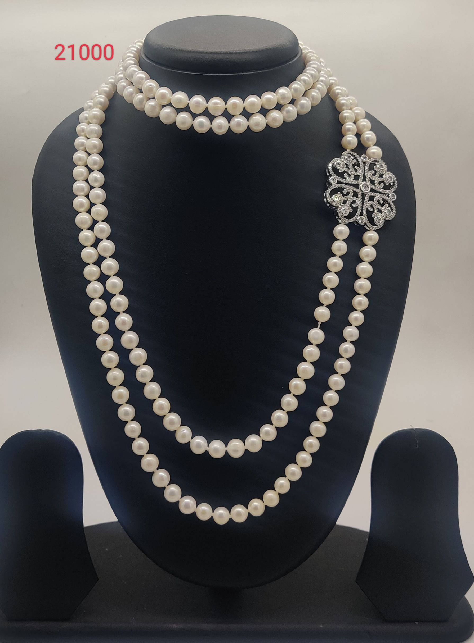 Regal Radiance freshwater pearl choker necklace set with layered round white pearls and stone-studded silver clasp