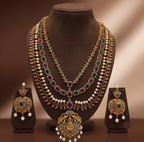 Royal triple line temple necklace set with pink and green stones, pearl drops, and matching heritage earrings.
