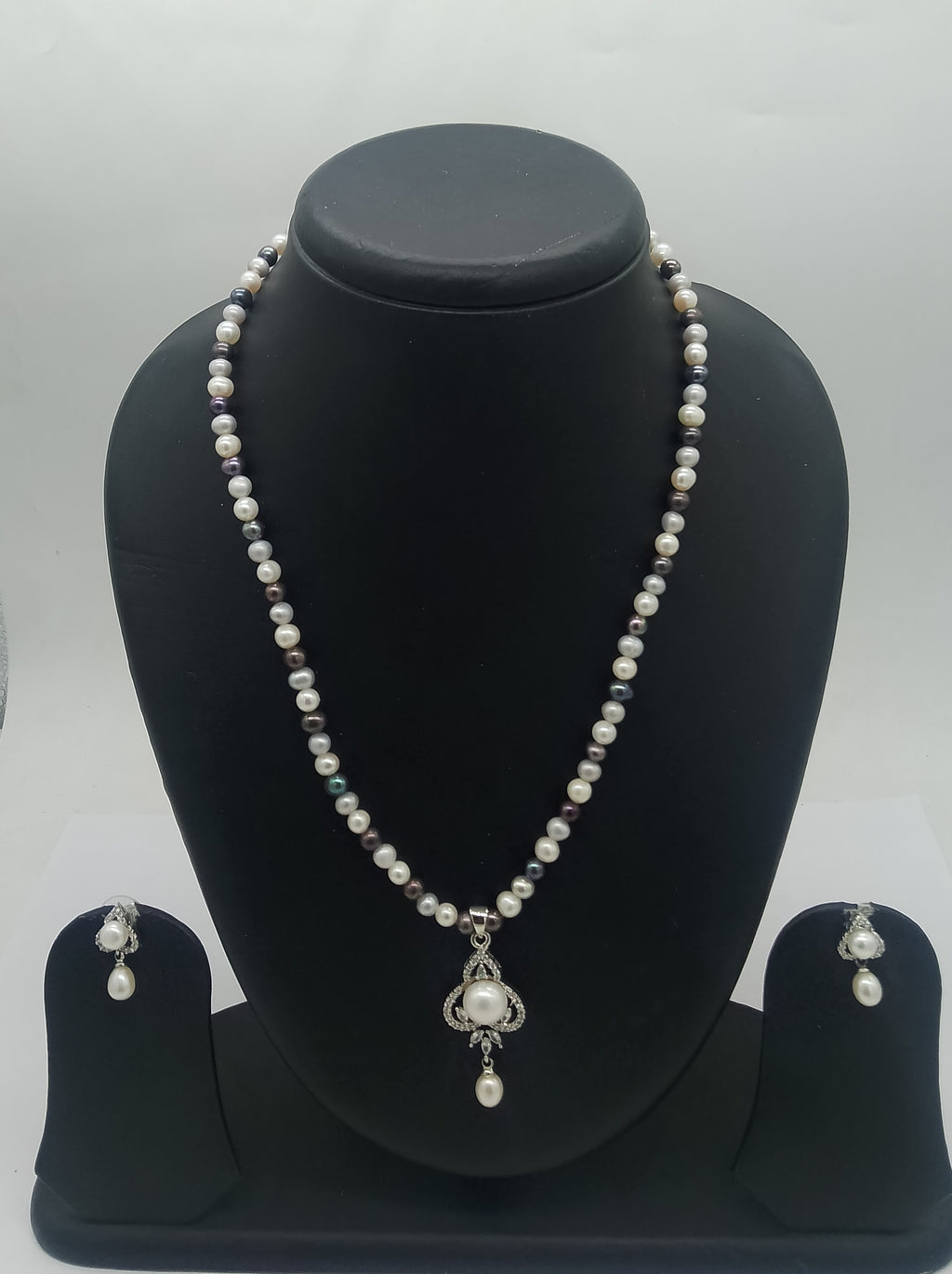 One line freshwater pearl necklace and earrings set with sculpted silver-toned pendant and dangling pearl