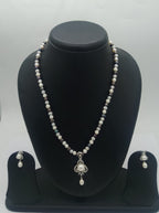 One line freshwater pearl necklace and earrings set with sculpted silver-toned pendant and dangling pearl