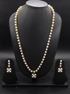 Single-line freshwater pearl long haram set with blue stone floral centerpiece and matching drop earrings.