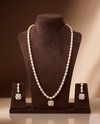 Single-line freshwater pearl long haram set with floral pearl centerpiece and matching drop earrings.