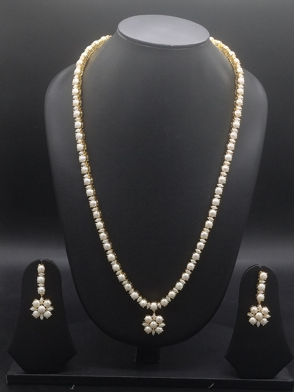 Single-line freshwater pearl long haram set with floral pearl centerpiece and matching drop earrings.