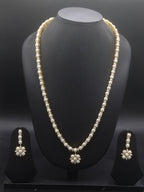 Single-line freshwater pearl long haram set with floral pearl centerpiece and matching drop earrings.